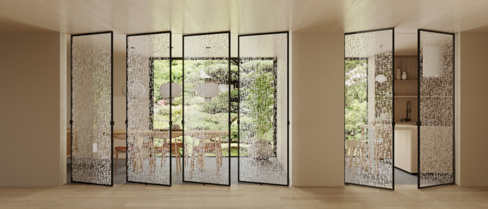 Glass architectural doors with patterned panels in black frames dividing interior and garden space