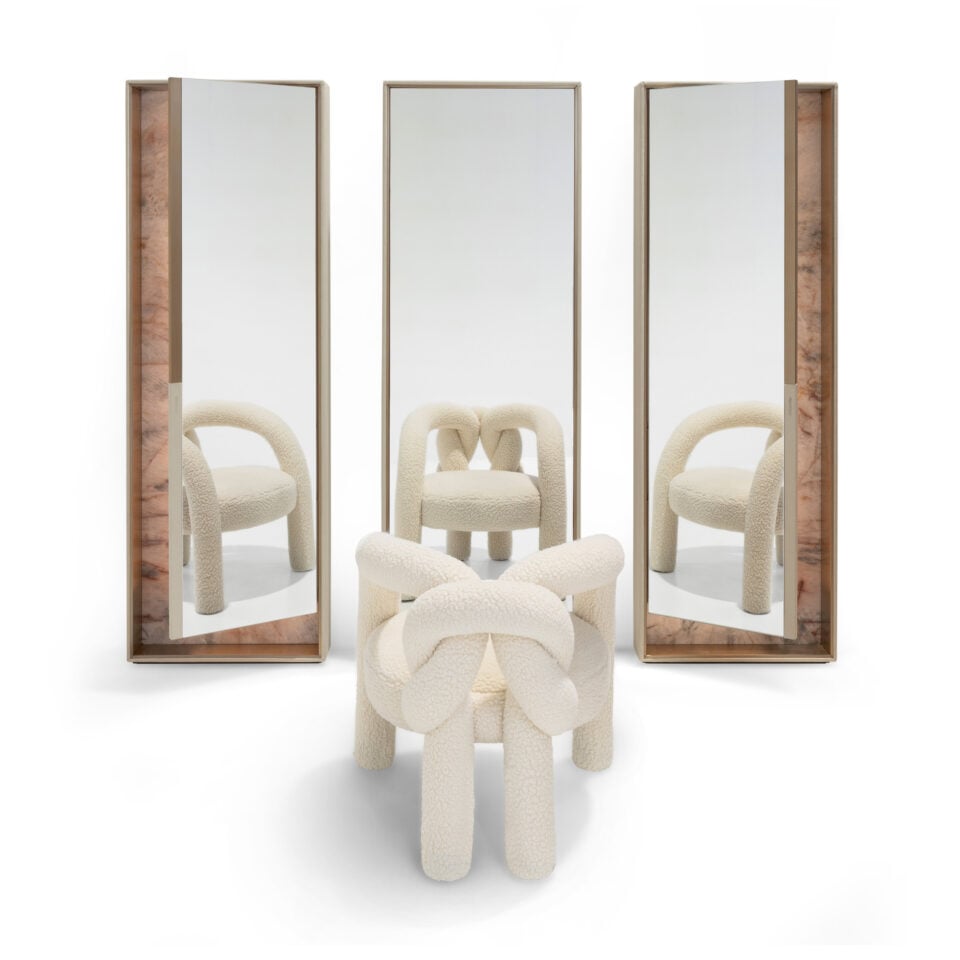 Rectangular glass and wood framed mirrors displayed behind a chair.