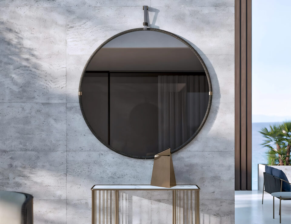 Round fabric-framed outdoor mirror mounted on wall
