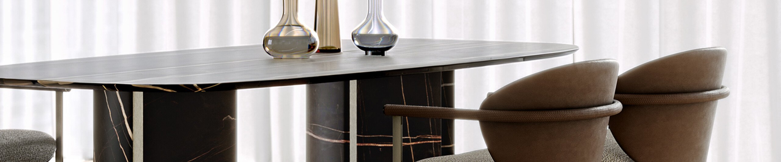 Marble dining table with upholstered chairs in neutral setting