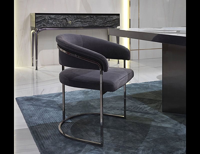 Upholstered armchair with metal frame beside table