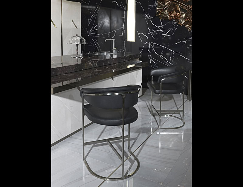 Black leather bar stools with metal frame at kitchen counter