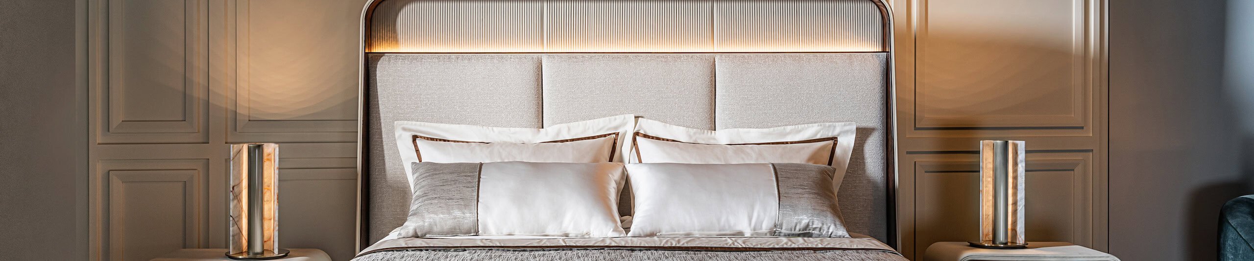 Upholstered bed with fabric headboard and wood frame in bedroom setting