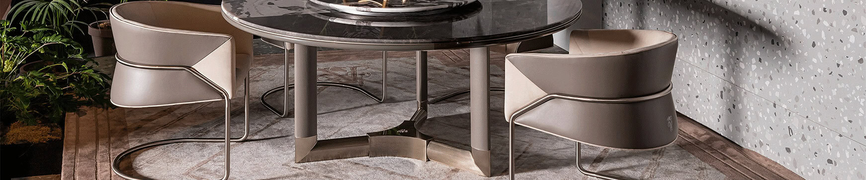 Round marble table with metal base and leather chairs