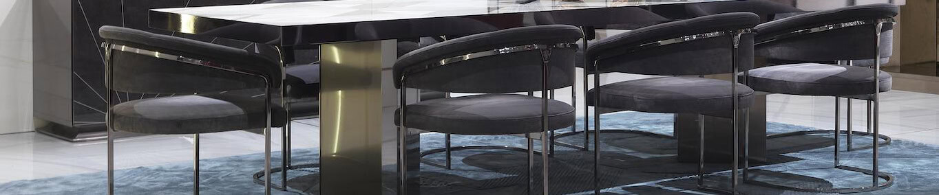 Metal dining chairs with upholstered seats around rectangular table