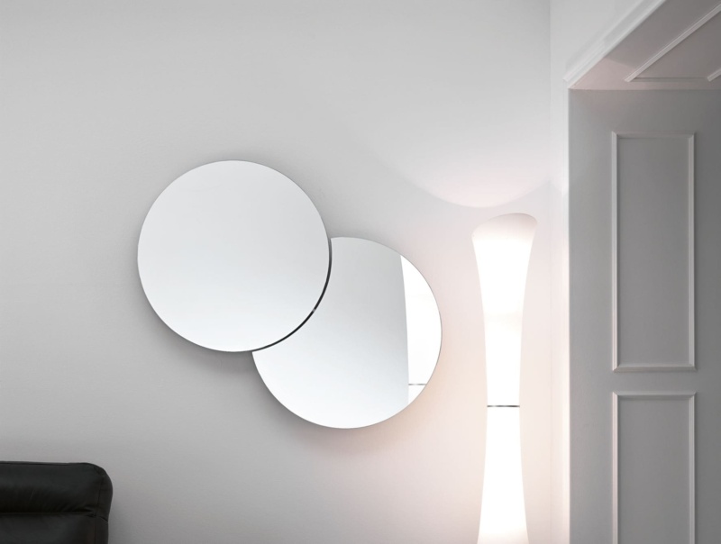 Two overlapping round wall mirrors with glass surface