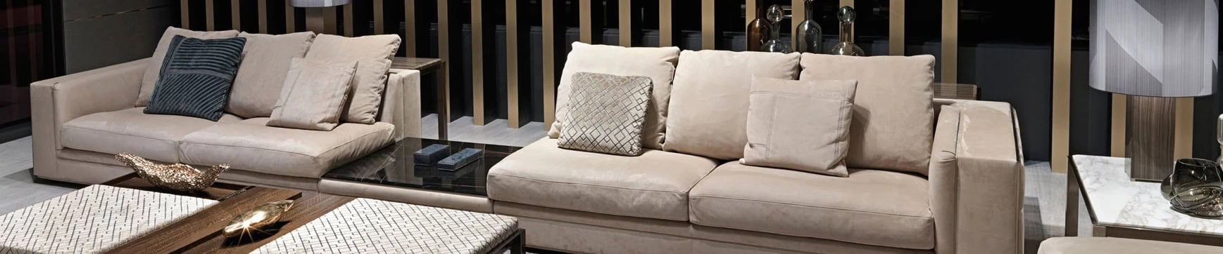 Beige leather sectional sofa with fabric cushions in living room setting