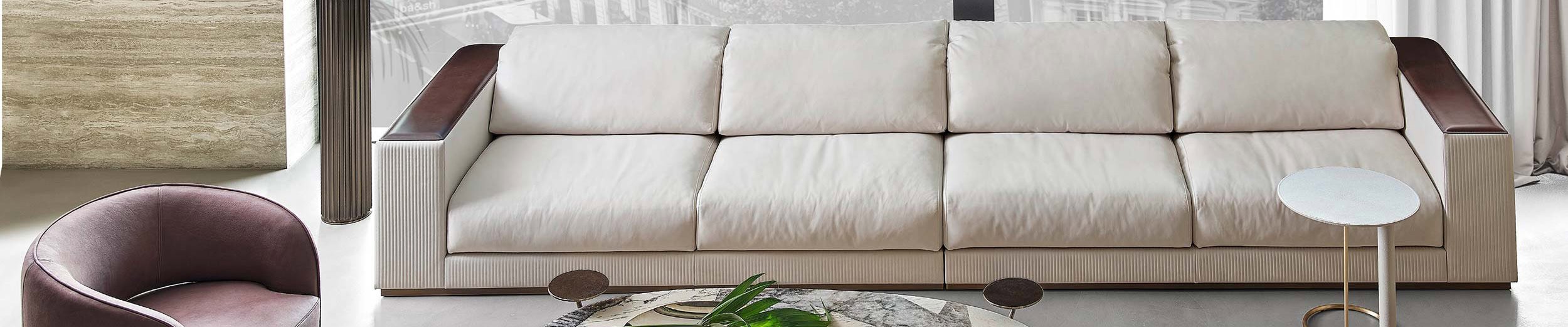 Beige leather sofa with wooden armrests in living room