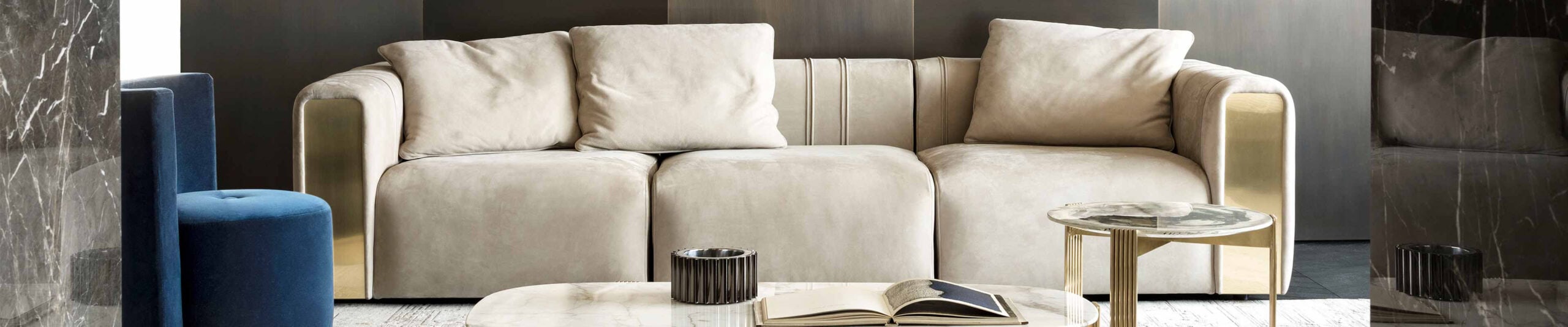 Beige fabric sofa with metal side panels in living room setting