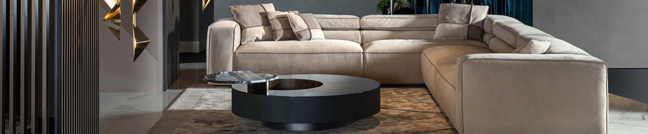 Beige fabric sectional sofa with cushions beside round coffee table