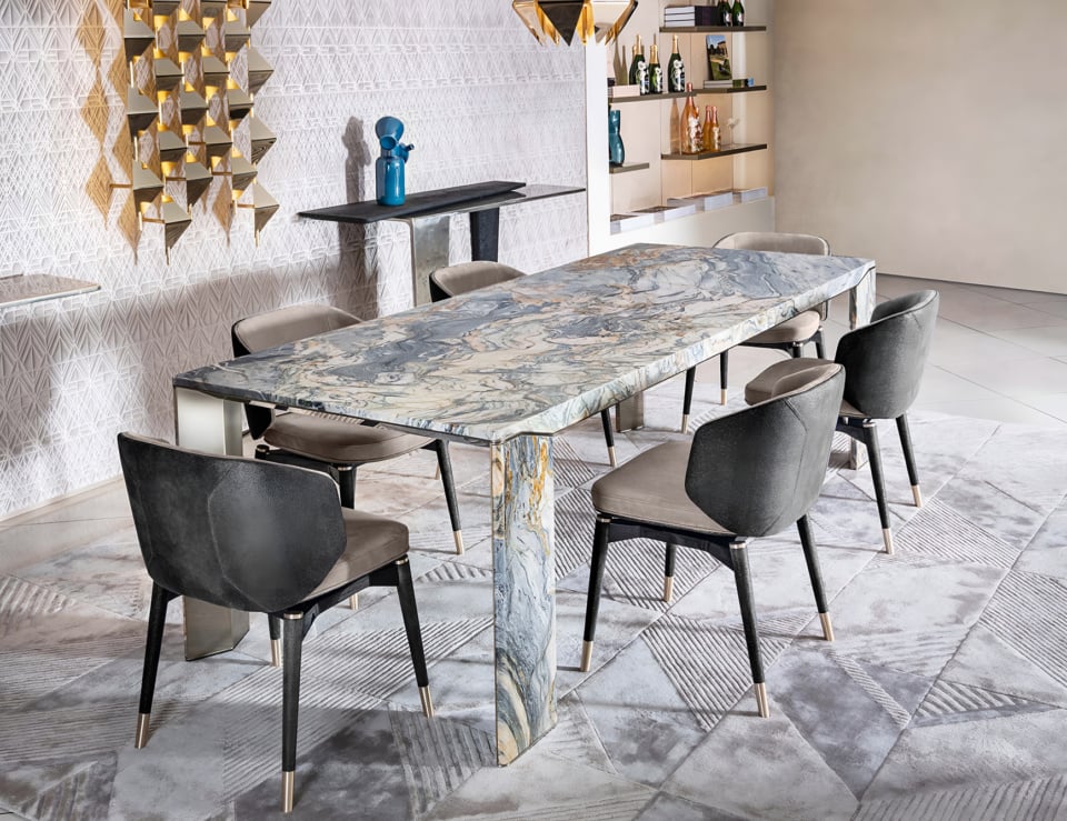 Rectangular marble dining table with fusion wow finish and six upholstered chairs in a dining room setting
